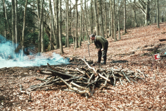 Roger Adams making charcoal in a pit: photo anon