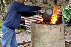 Charging the Furness - A charge of ore + charcoal is added to the (earlier) furnace; between 15 and 25 charges may be added for one smelt lasting a day. The roasted ore has been broken to roughly 10mm, by gently hammering to limit the dust produced (the dust may not add to the iron produced). Because as-bought charcoal is normally too large a heavy roller is arranged to roll along two rails about 20mm thick, this produces